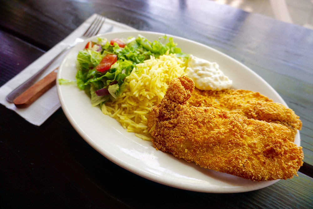 A plate of golden-fried Catfish and Seasoned Rice at Habesha Cafe.